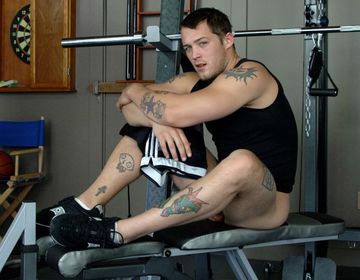 Inked jock with no shorts before a work out