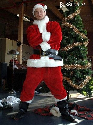 Cute young guy dressed in Santa suit