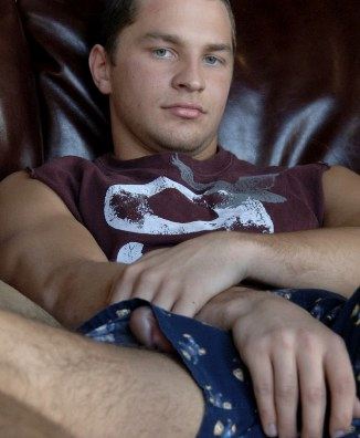 Cute young jock in boxers with his dick poking out