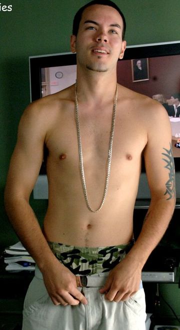 Masculine boy-next-door shirtless with a big chain and his boxers showing