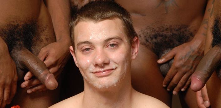 Xenar with his face covered in cum surrounded by big black dicks