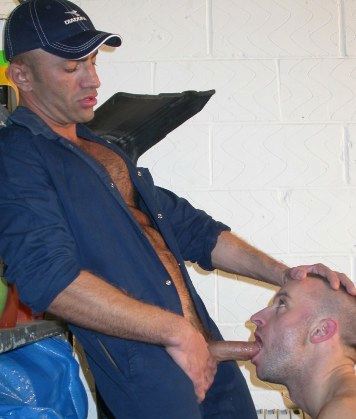 Danny Cannon pulls cock out of his jumpsuit and into the mouth of a tall stranger. 