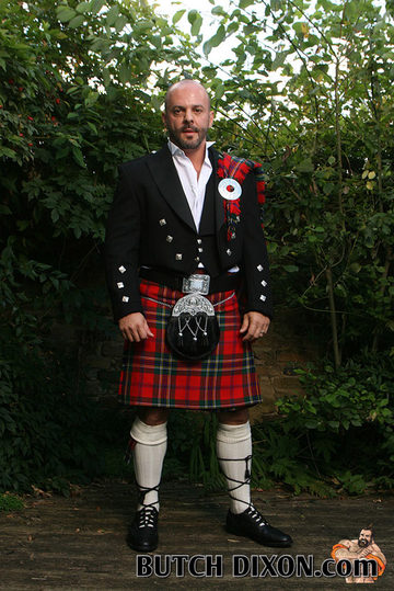 Hunky guy in a shaved head in a kilt