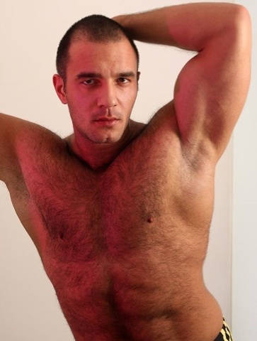 hot, hairy man shows pit and smoldering look