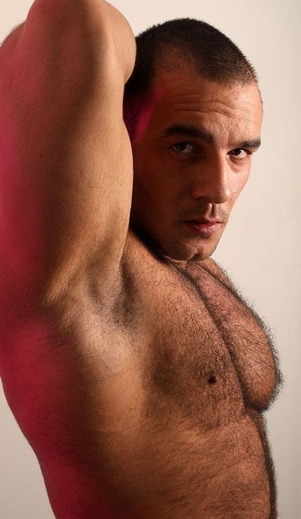 beefy, hairy guy shows armpit