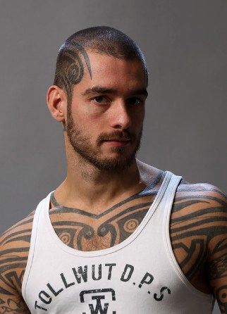 Tattooed stud Logan McCree in white tank top