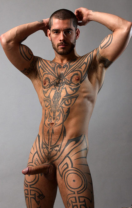 Muscle jock Logan McCree shows off his hard cock and tattoos