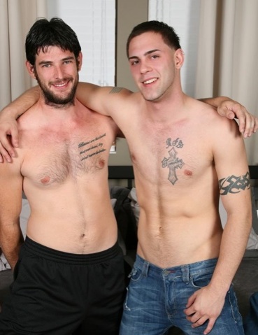 Young tattooed punk and bearded guy embrace