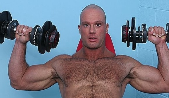 Bald hunk shows how big his muscles are
