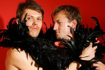 Twinks camp it up with a black feather boa