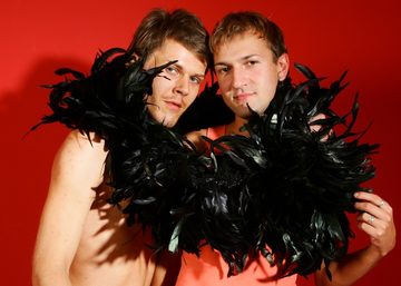 Campy twinks play with a feater boa