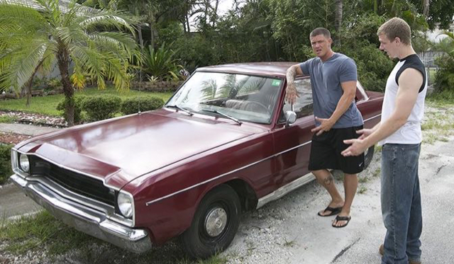 Good 'ol southern boys talk by an old car