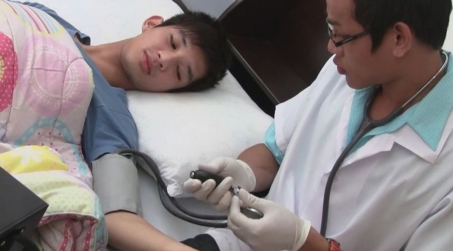 Young Asian Doctor examines his patient