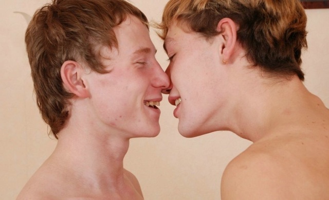 Cute young shirtless guys about to kiss