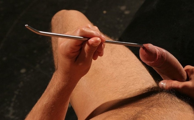 Hard uncut cock with a sounding rod being insterted
