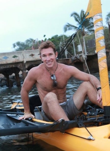 Cute hairy jock in a boat on the river
