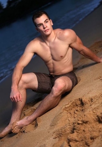 Hot muscle jock in the beach sand