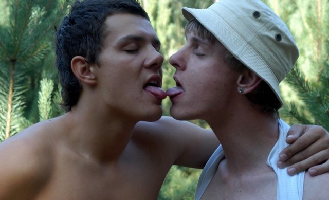 Two twinks touching tongues.