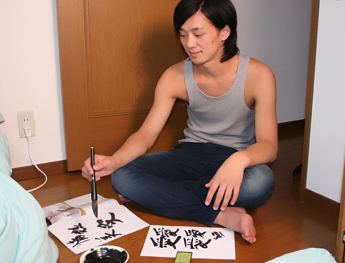 Young Asian twink writing