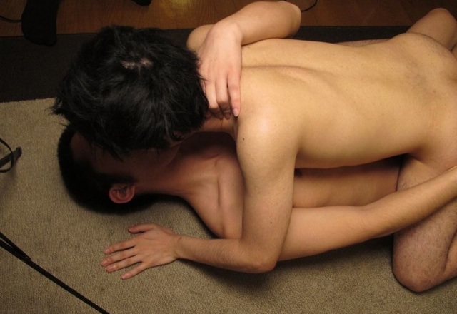 Naked young guys make out on the floor