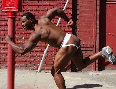 Black bodybuilder running in a jockstrap