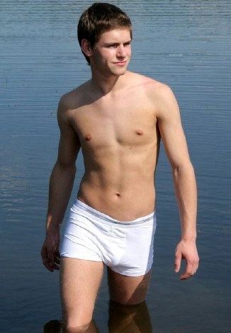 Hot twink Axel coming out of the water in white underwear
