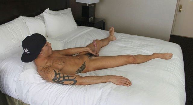 Tattooed Latin thug jerking off on bed
