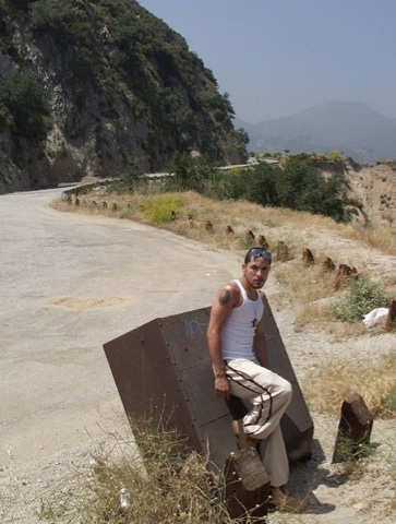 Cute latin guy on the side of a mountain road