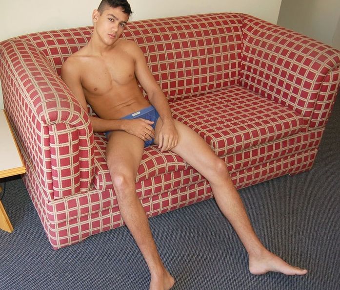 Smooth young jock in his underwear on the couch