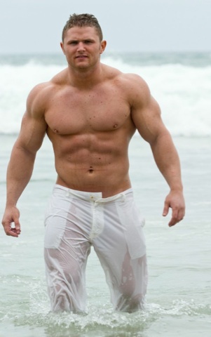 Beefy body builder Rusty Winchester comes out of the water with wet white pants