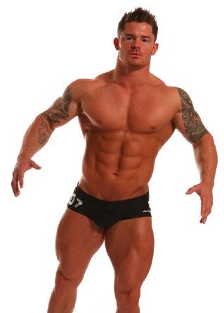 Mitchell Rock - Massive tattooed bodybuilder in a swim suit showing his huge torso and monster legs
