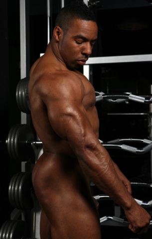 Naked muscled arm and ass of black body builder Alan Demond