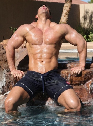 Muscle god Zeb Atlas in wet swimsuit with head tilted back in ecstasy