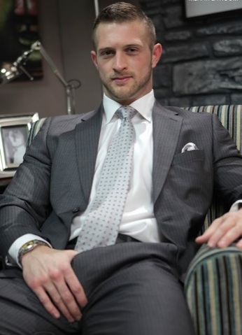 Scruffy stud Paul Wagner plays with his hard on through his suit pants