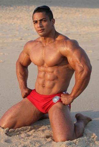 Julio in red shorts on the beach