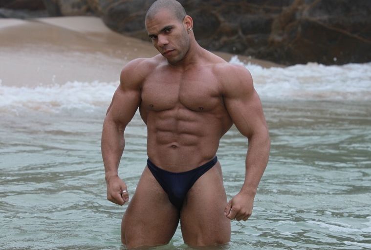Muscle boy Lucius shows off his ripped abs and huge deltoids at the beach