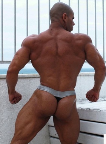 Lucius Blaque flexes his back muscles and shows off his ass