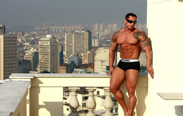 Muscled body builder Samuel Vieira on a balcony