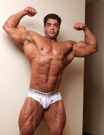 Brutus Difino flexing his huge arms and chest