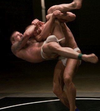 Two guys wrestling in jockstraps