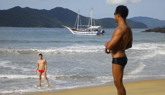 Black guy sees a hot skinny Latino coming out of the water with a sailing ketch anchored offshore.