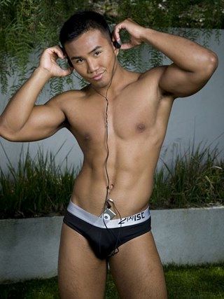 Muscled smooth Asian boy outside