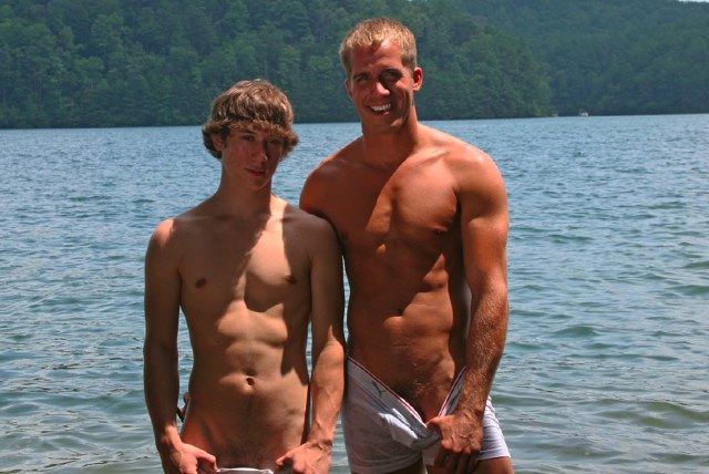 Ripped jock and young twink playing in the water