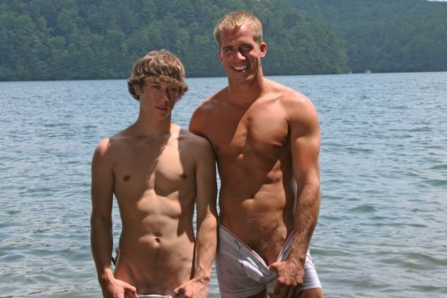 Ripped jock and young twink playing in the water