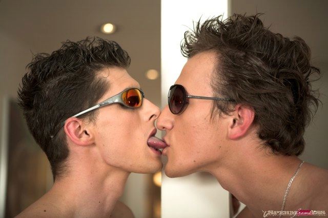 Two hot thin young guys in sunglases french kissing