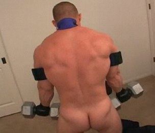 Muscle guy doing bicep curls with barbells while naked