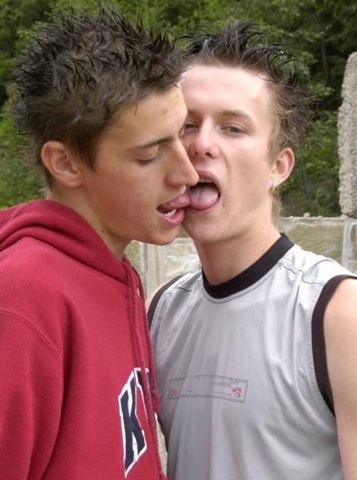 Two cute young guys tongue wrestling