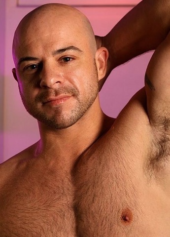 Bald hairy stud shows his pit and erect nipple
