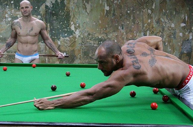 Two studs play a gme of snooker in their underwear