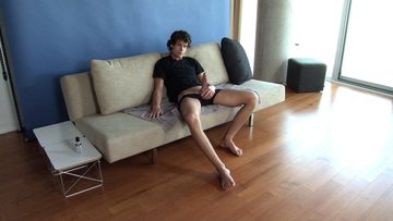 Young twink with a huge dick on the couch